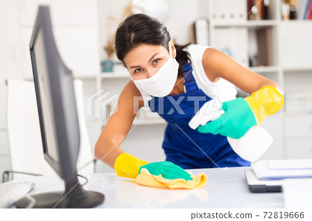 Female cleaner working in protective mask productively on task Female cleaner working in protective mask productively on task 72819666