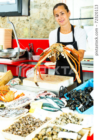 Polite woman demonstrating european spider crab 72820113