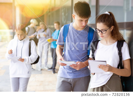 Boy and girl discuss homework after college Boy and girl discuss homework after college 72820136