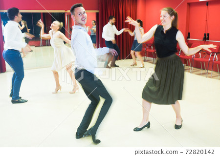 Motion blur of dancing couples 72820142