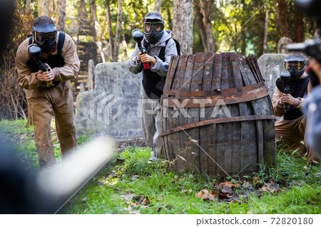 Men and women playing paintball 72820180
