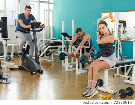 Sporty girl with dumbbells foreground 72820610