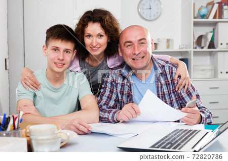 Happy family working with documents Happy family working with documents 72820786
