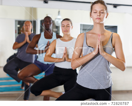Jolly people exercising during yoga class 72820787