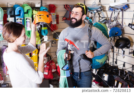 Young couple buying climbing equipment in store Young couple buying climbing equipment in store 72820813
