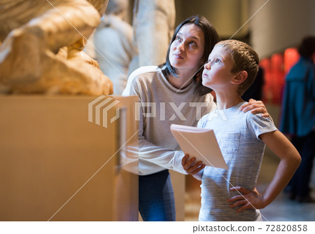 Woman and boy visiting sculptures exhibition Woman and boy visiting sculptures exhibition 72820858