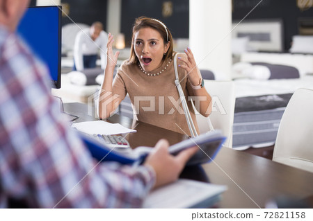 Outraged customer expresses dissatisfaction with the manager in furniture store 72821158