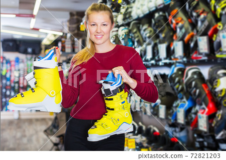 girl is demonstrating boots for skiing 72821203
