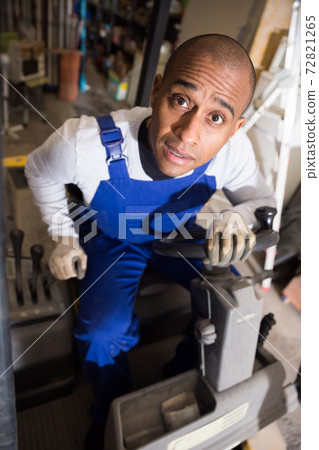 Closeup face of surprised hispanic worker sitting on forklift truck 72821265
