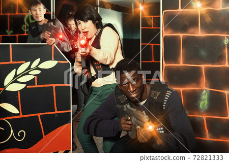 Multiracial couple playing lasertag 72821333