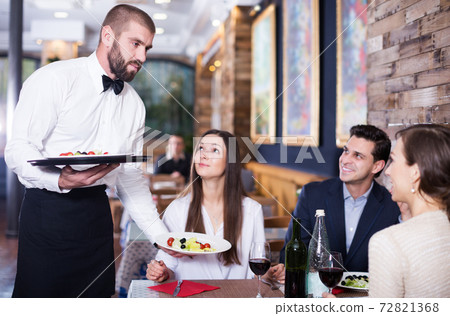 waiter man serving company at restaurant waiter man serving company at restaurant 72821368