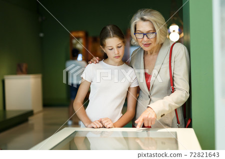Woman and girl visiting museum Woman and girl visiting museum 72821643