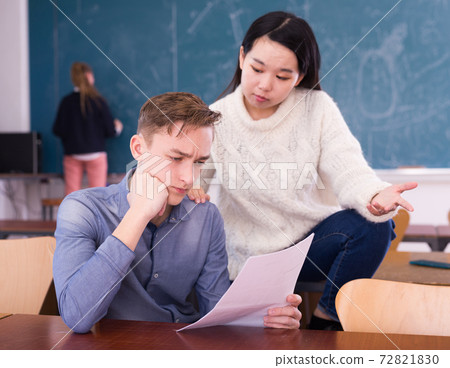 Girl and guy university students preparing for exams Girl and guy university students preparing for exams 72821830