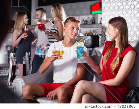 Female and male clubbing with cocktail in the club on party Female and male clubbing with cocktail in the club on party 72821865