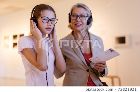 People using audio guide in museum People using audio guide in museum 72821921