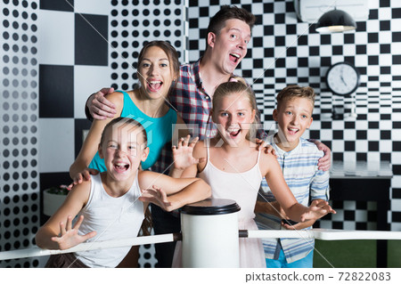 Parents with their children are satisfied after visit of escape room 72822083