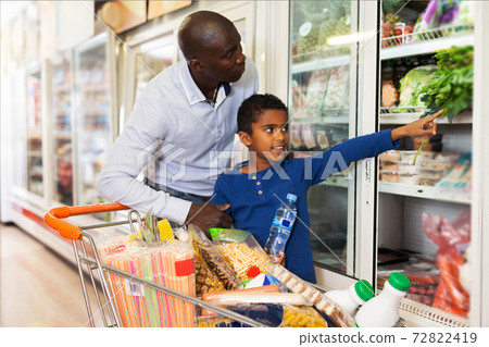 African American man with his son making purchases African American man with his son making purchases 72822419