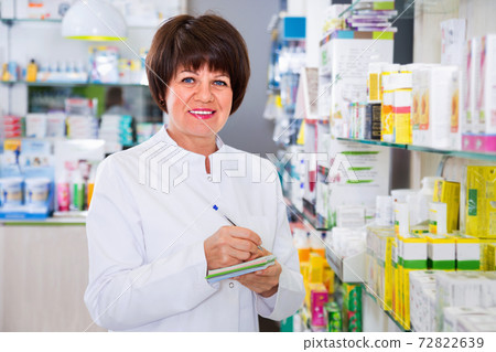 Portrait of female druggist working in pharmacy Portrait of female druggist working in pharmacy 72822639