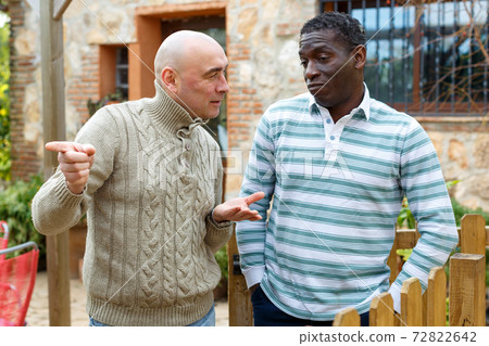 Smiling neighbors discussing 72822642