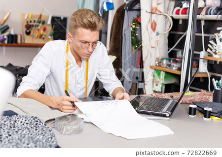 Tailor creating pattern using graphics tablet Tailor creating pattern using graphics tablet 72822669