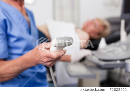 Doctor holding tools for ultrasound test Doctor holding tools for ultrasound test 72822921