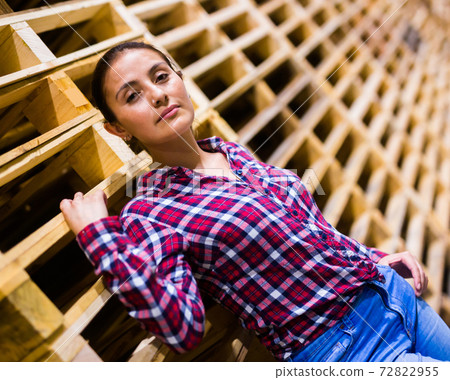 Portrait of latino woman standing in warehouse 72822955