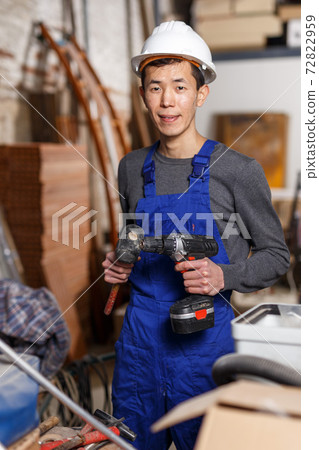 Worker holding power tools Worker holding power tools 72822959