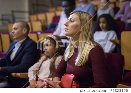 Woman watching theatrical performance in theater hall 72823196