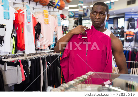 Positive Afro man buying sports clothes Positive Afro man buying sports clothes 72823519