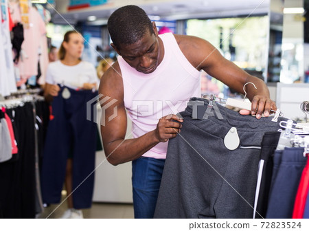 Man buying sportswear Man buying sportswear 72823524
