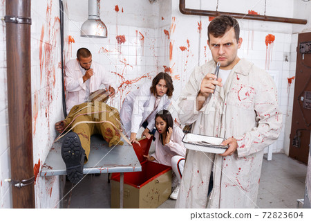 Young man in quest room with bloody traces Young man in quest room with bloody traces 72823604