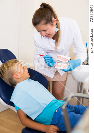 Young doctor in white is telling about healthcare Young doctor in white is telling about healthcare 72823642
