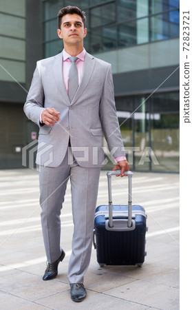 Businessman carrying suitcase Businessman carrying suitcase 72823721