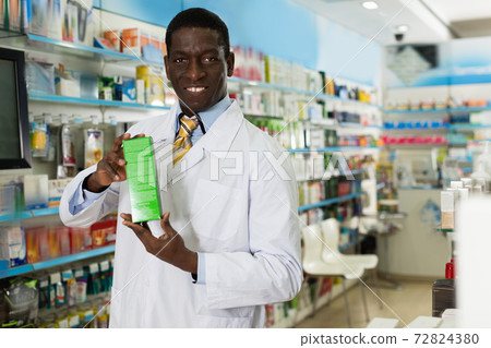 Portrait of experienced male pharmacist counseling about medicines in pharmacy Portrait of experienced male pharmacist counseling about medicines in pharmacy 72824380