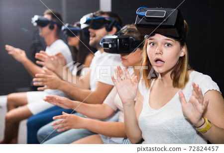 Portrait of frightened young girl after watching of exciting movie with VR glasses Portrait of frightened young girl after watching of exciting movie with VR glasses 72824457