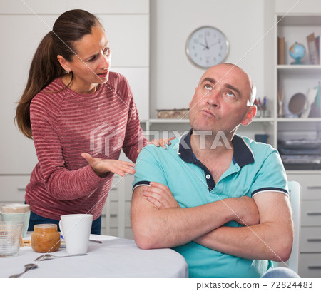 Unhappy family couple discussion while quarrel in home interior 72824483