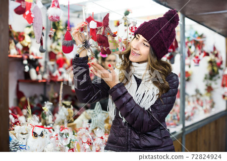 Portrait of female customer near counter with Christmas gifts Portrait of female customer near counter with Christmas gifts 72824924