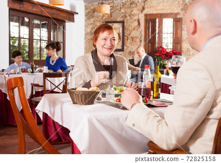 Man and his mother at restaurant Man and his mother at restaurant 72825158