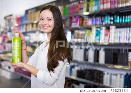 Woman customer demonstration hair shampoo at beauty shop Woman customer demonstration hair shampoo at beauty shop 72825384