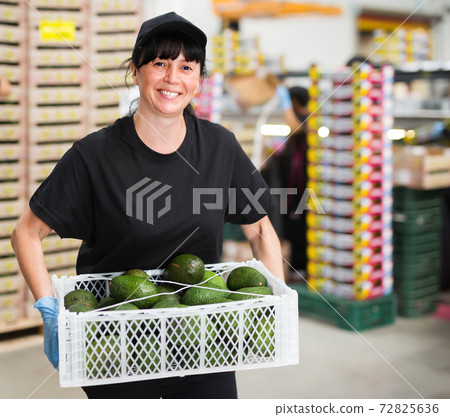 Nice woman working at fruit warehouse Nice woman working at fruit warehouse 72825636