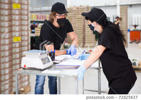 Man and woman talking and signing documents Man and woman talking and signing documents 72825637