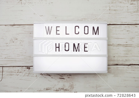 Top view of Welcome Home text in light box on wooden background Top view of Welcome Home text in light box on wooden background 72828643