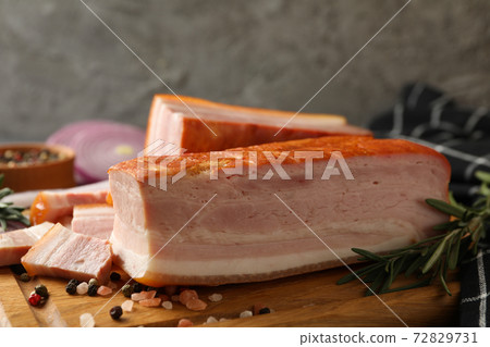 Concept of tasty snack with bacon on wooden board, close up 72829731