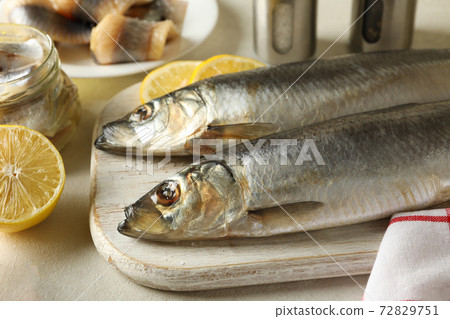 Concept of tasty lunch with fresh herring fish on white textured background 72829751