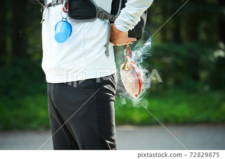 People who enjoy outdoor sports such as camping using portable mosquito coils to repel insects outdoors 72829875