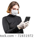 Young woman in medical protective mask with smartphone 72831972