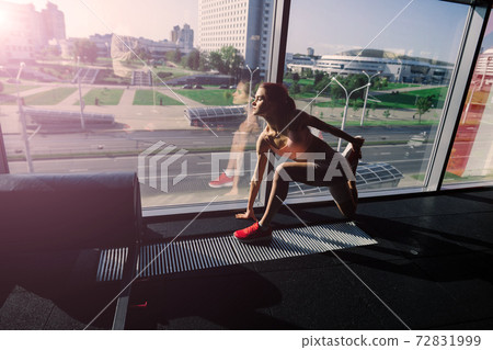 Athletic girl in sportswear performs exercises with barbell, dumbbells. Fitness, healthy lifestyle Athletic girl in sportswear performs exercises with barbell, dumbbells. Fitness, healthy lifestyle 72831999