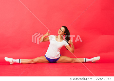 Beautiful young fit gymnast woman in sportswear working out, performing art gymnastics element Beautiful young fit gymnast woman in sportswear working out, performing art gymnastics element 72832052
