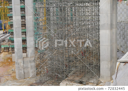 MALACCA, MALAYSIA -MARCH 14, 2020: Construction workers working at height at the construction site. They are supplied with harnesses and other safety equipment to prevent them from having an accident. 72832445