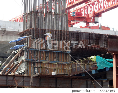 MALACCA, MALAYSIA -MARCH 14, 2020: Construction workers working at height at the construction site. They are supplied with harnesses and other safety equipment to prevent them from having an accident. 72832465